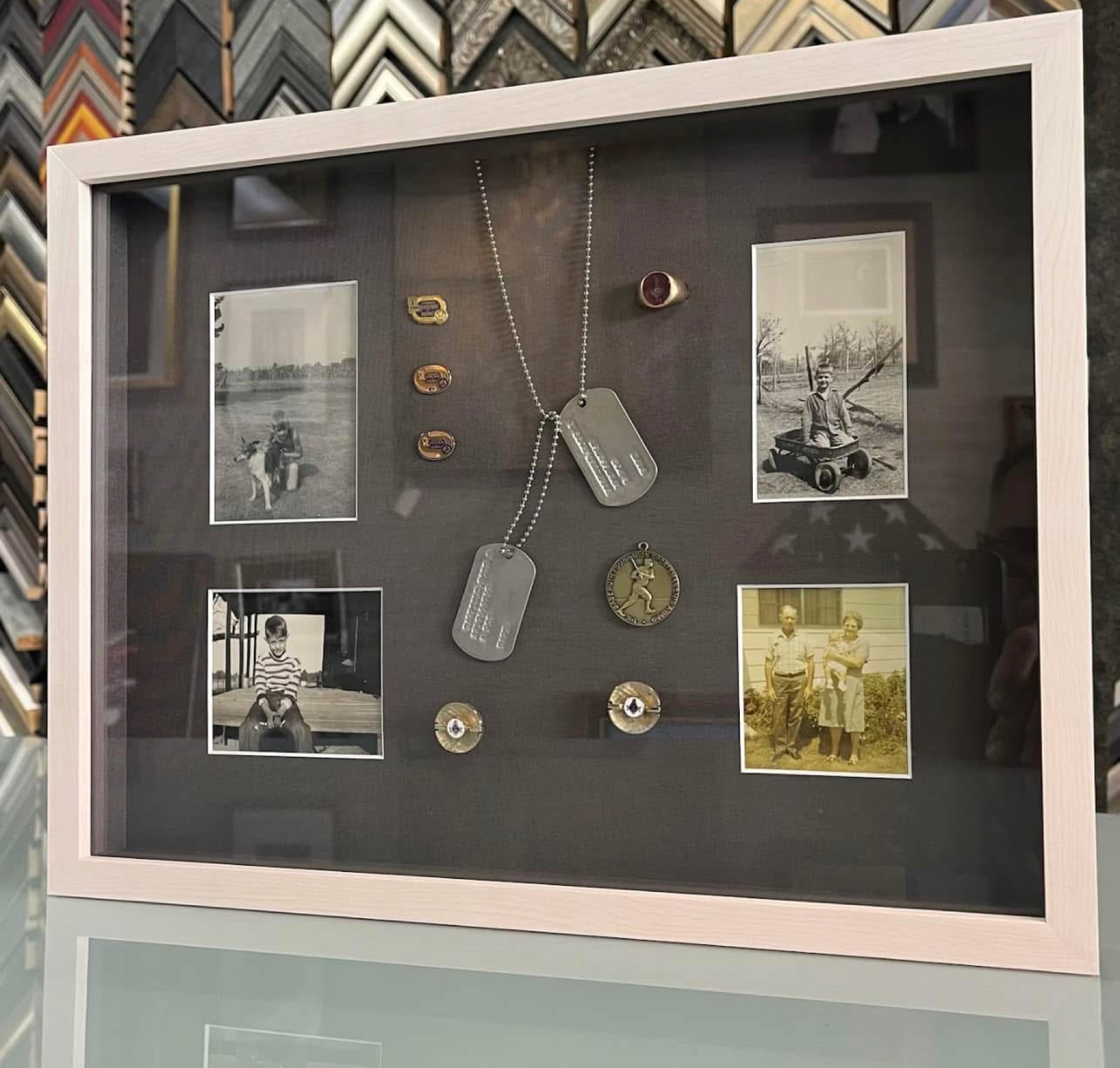 Military memorabilia shadowbox with dog tags and photographs custom-framed by The Frame Up in Ruston, Louisiana